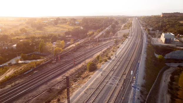 Aerial view of railway tracks running into the distance at sunset