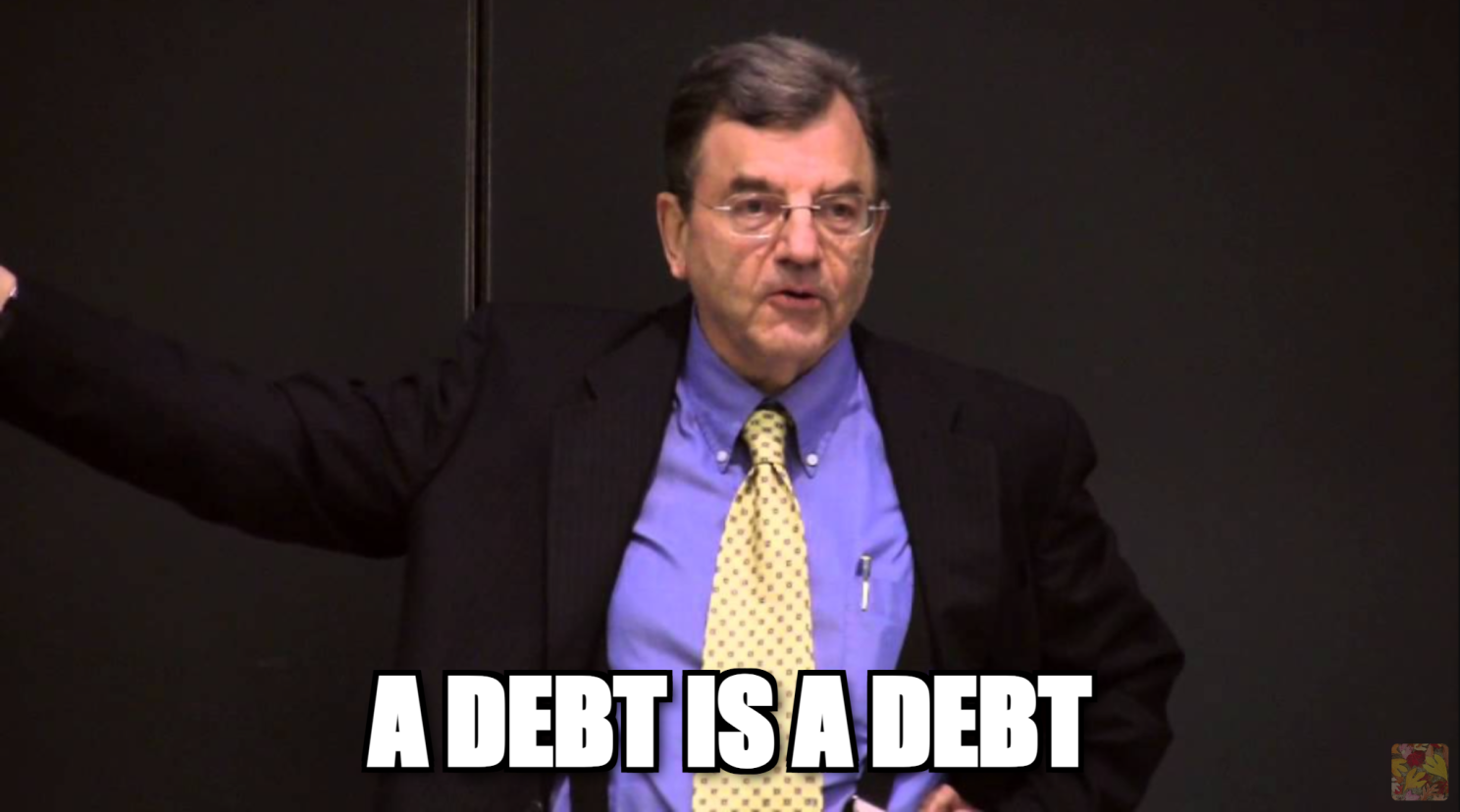 Economic historian Michael Hudson lecturing, captioned 'A DEBT IS A DEBT'