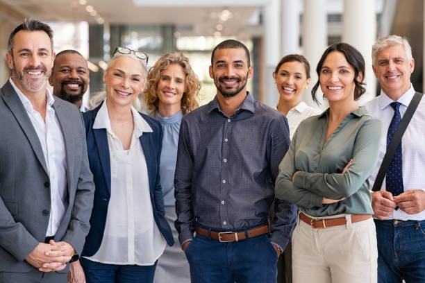 A diverse group of professionals standing together in an office